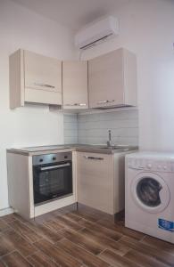 a kitchen with a washing machine and a washer at La Bellavista Mola di Bari in Mola di Bari