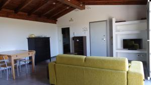 a living room with a couch and a table at Masseria Donna Laura di Adriana Giangrande in Arnesano