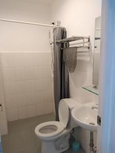 a bathroom with a toilet and a sink at The Uptown Place Condominium in Iloilo City