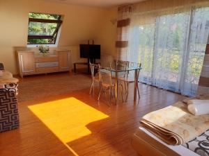 a living room with a table and a dining room at Willa za Strugiem in Zakopane