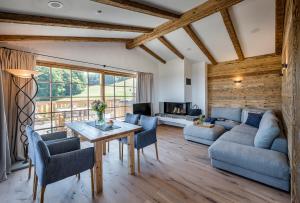 a living room with a table and a couch at Chiemsee Chalet in Frasdorf
