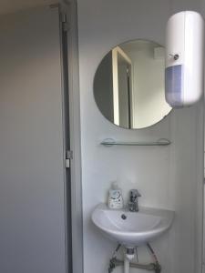 a bathroom with a sink and a mirror at Event Lodge Camping Spielberg in Spielberg
