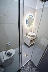 a bathroom with a shower and a toilet and a sink at Petite palace in Rethymno Town +20 photos