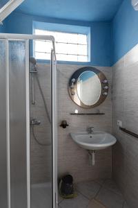 a bathroom with a sink and a mirror at Ostello di Germagno in Omegna