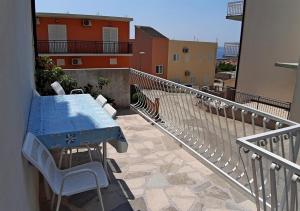 a blue table and chairs on a balcony at Makarska Best Buy Apartments in Makarska