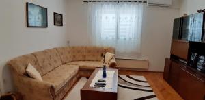a living room with a couch and a coffee table at Makarska Best Buy Apartments in Makarska
