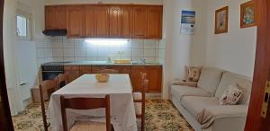 a small kitchen with a table and a couch at Makarska Best Buy Apartments in Makarska