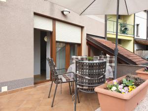 a patio with a table and chairs and an umbrella at Apartments Ziher in Zagreb