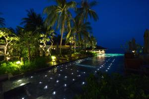 a resort swimming pool at night with lights at Banana Fan Sea Resort in Chaweng