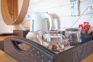 a kitchen counter with a black holder with glasses at Sunset Villa Hotel in Kaş
