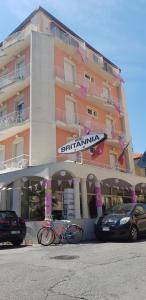 a building with a bike parked in front of it at Hotel Britannia in Rimini