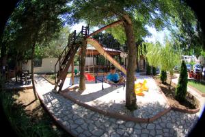 a boy is sitting on a swing set in a park at Vila Casa Leul in Jupiter
