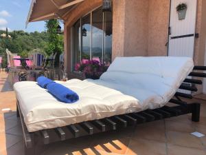 a bed on the porch of a house at Grimaldines - Villa in Cagnes-sur-Mer