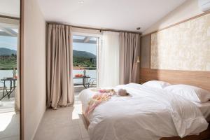 a bedroom with a bed with a teddy bear on it at Astra Sarti Luxury Suites in Sarti