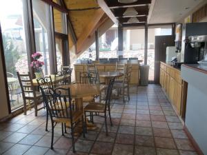 a restaurant with tables and chairs in a room at Days Inn by Wyndham Colorado Springs/Garden of the Gods in Colorado Springs