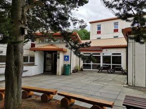 a building with benches in front of a courtyard at Inverness Youth Hostel in Inverness