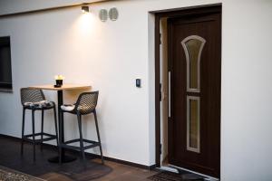 a room with a table and two chairs next to a door at Guesthouse Urša in Preddvor