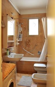 łazienka z wanną, umywalką i toaletą w obiekcie Anna's Apartment, the Heart of Bologna. w Bolonii