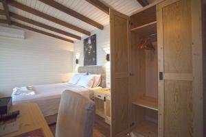 a small bedroom with a bed and a desk and a table at Sunset Villa Hotel in Kaş
