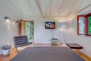 a bedroom with a bed and a tv on the wall at DVORAC “KAŠTIL JELA” in Milna