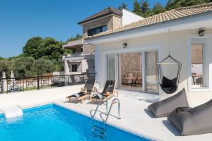 a villa with a swimming pool and a house at Arsenoi's Pool Villa in Skala Potamias