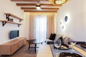 a living room with a couch and a tv at Theros in Rethymno