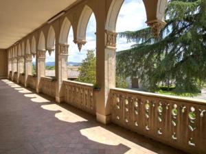 a balcony with arches on a building with a view at Mas El Ricart in Malla