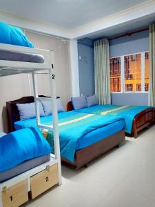a bedroom with two bunk beds and a window at DaLat Sky Hostel in Da Lat