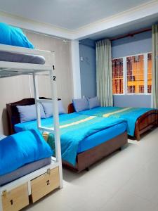 Postel nebo postele na pokoji v ubytování DaLat Sky Hostel