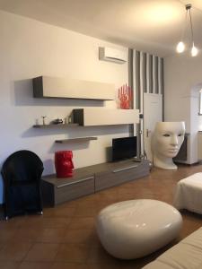 a living room with a bed and a couch and a table at Dimora del Podestà in CastellʼArquato