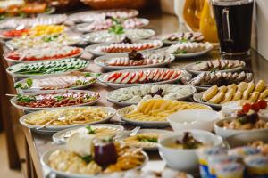 a buffet with many plates of food on a table at Grand Podhale Resort&Spa- Jacuzzi - Sauna fińska i Łaźnia parowa - Widok na Tatry in Zakopane