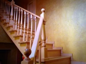 a staircase with white railings in a home at Міні-готель Пекін in Mykolaiv