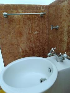a bathroom with a white sink and a toilet at Olivella Suite Ecological House in Palermo