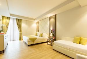 Posteľ alebo postele v izbe v ubytovaní Hotel Villa Garuti