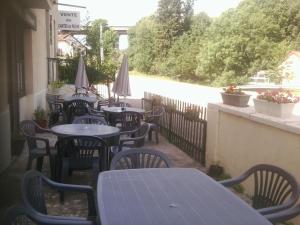 a row of tables and chairs on a patio at Auberge du Pont d'Ouche in Thorey-sur-Ouche