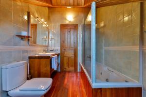 a bathroom with a toilet and a tub and a sink at Casa Rural La Chata by Vivere Stays in Valsain +15 photos