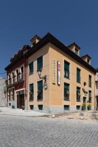 a building on the side of a street at Casa Rural La Chata by Vivere Stays in Valsain
