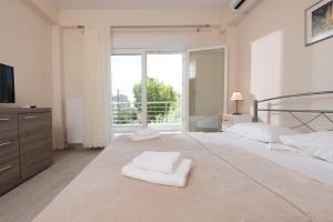 a bedroom with a bed with two white towels on it at Villa Venetta in Skala Rachoniou