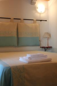 En eller flere senge i et værelse på B&B Piazza di L'Ara