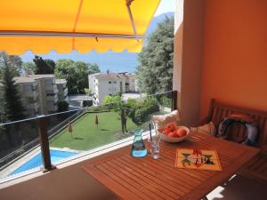 a table with a bowl of fruit on a balcony at Bellavista in Locarno