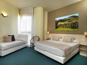 Llit o llits en una habitació de Hotel Ristorante Alcide
