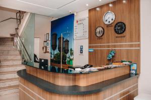 a shop with clocks on the wall and stairs at Samir Hotel Business in Porto Velho