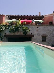 a swimming pool in front of a house at VILLA ARTEMiA in Sigean