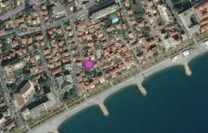 arial view of a city with a pink circle on the water at Villa du Cros in Cagnes-sur-Mer