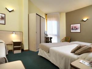 Voodi või voodid majutusasutuse Hotel Ristorante Alcide toas