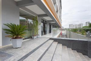 a balcony of a building with potted plants on it at StayBird - B Suite, Business Hotel, Kharadi in Pune