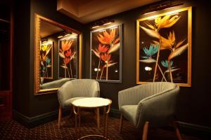 a living room filled with furniture and a painting on the wall at The Bedford Balham in London