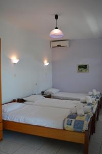 Postel nebo postele na pokoji v ubytování GLIKERIA ROOMS