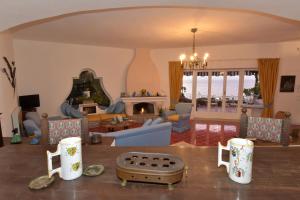 a living room with a couch and a table at Aglaia Luxury Seaview Villa in Ischia
