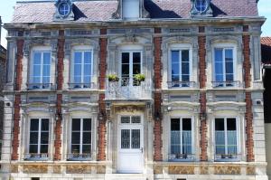 a brick building with white doors and windows at LE JABLOIRE in Florent-en-Argonne